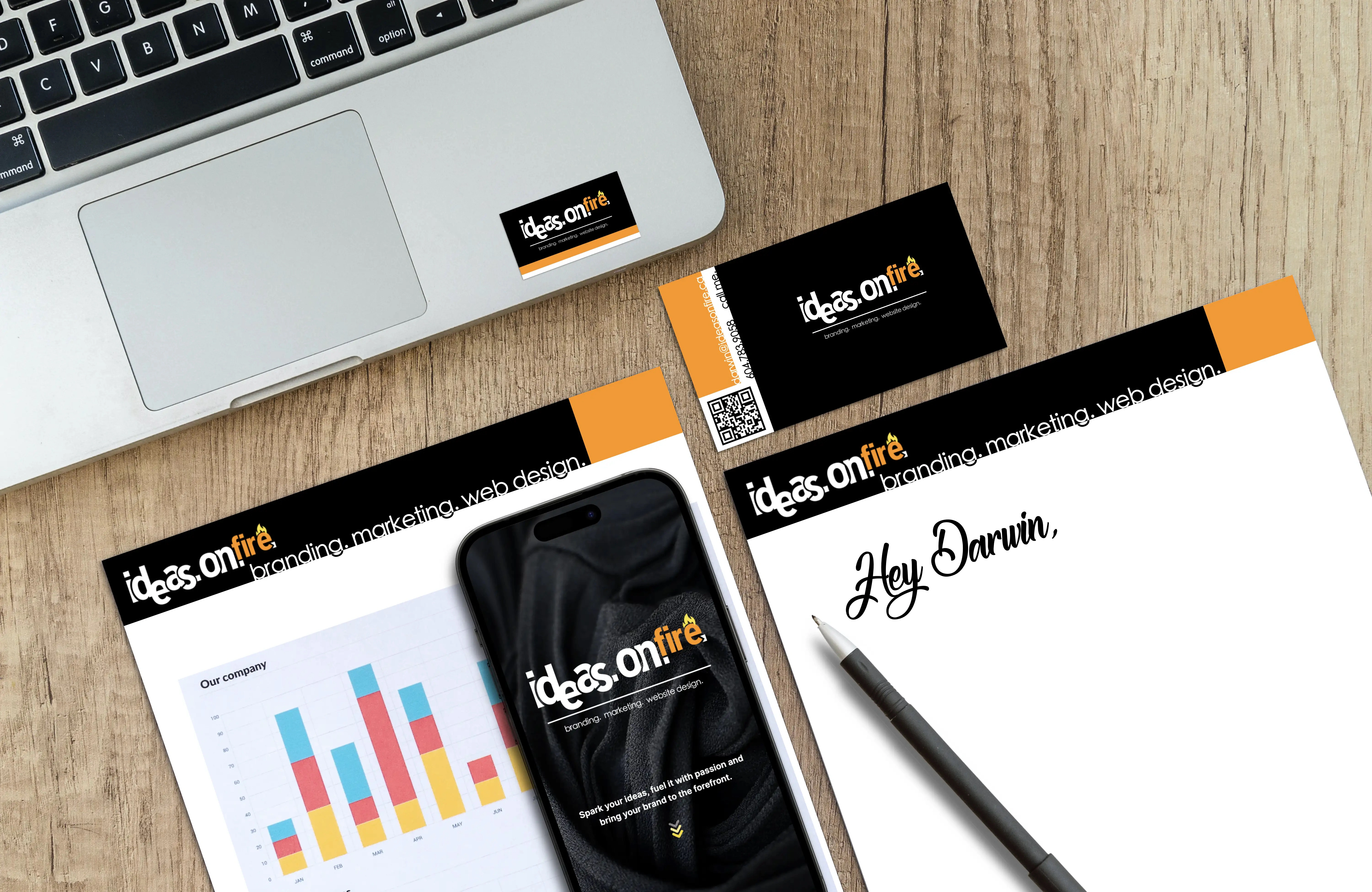 Ideas.on.fire branding across a business card, stationery, a laptop sticker, and a phone screen